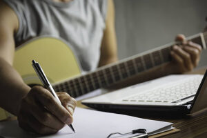 pngtree musical composer penning lyrics on paper with a pencil photo photo 30724066